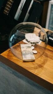 clear glass fish bowl on brown wooden table