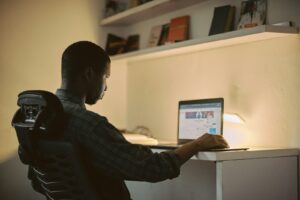 man in black long sleeve shirt using macbook pro