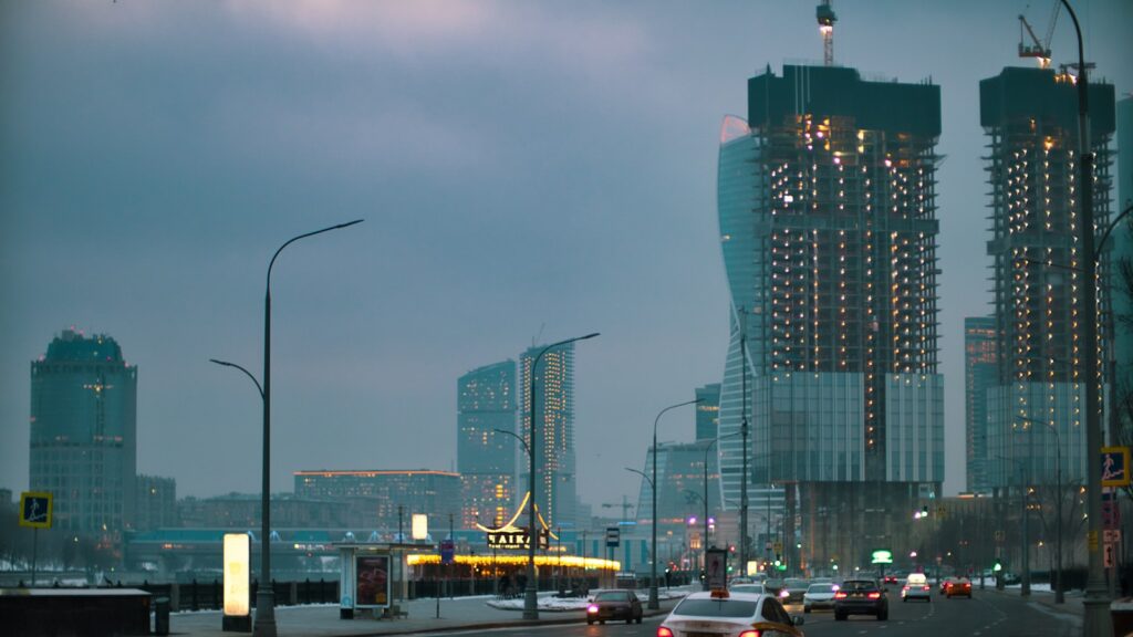 cars on road near high rise buildings during daytime