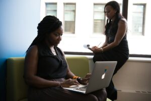 shallow focus photo of woman using MacBook